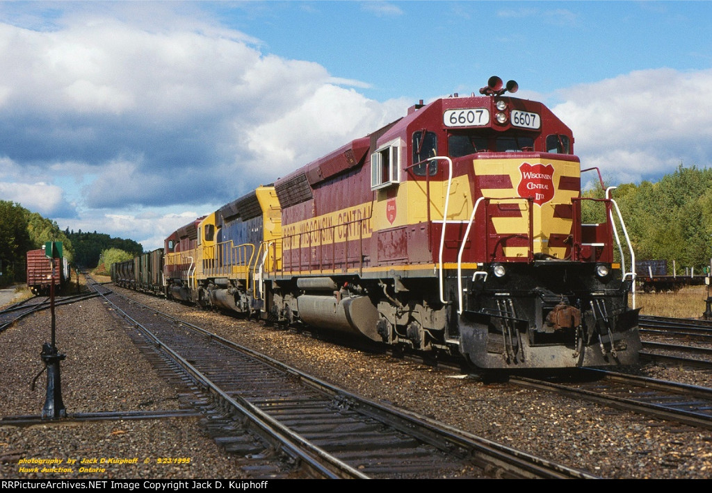 WC, Wisconsin Central SD45s 6607-5337-6541 leads a southbound ore train on the ex-Algoma Central at Hawk Junction, Ontario. September 23, 1995. 
